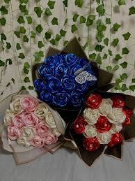 three ribbon rose bouquets, blue with black wrapping anf a butterfly add on
pink and white, pink wrapping
white and red with black warpping